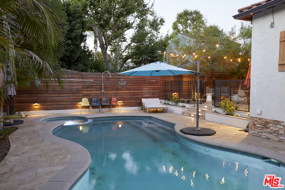 a swimming pool with outdoor seating