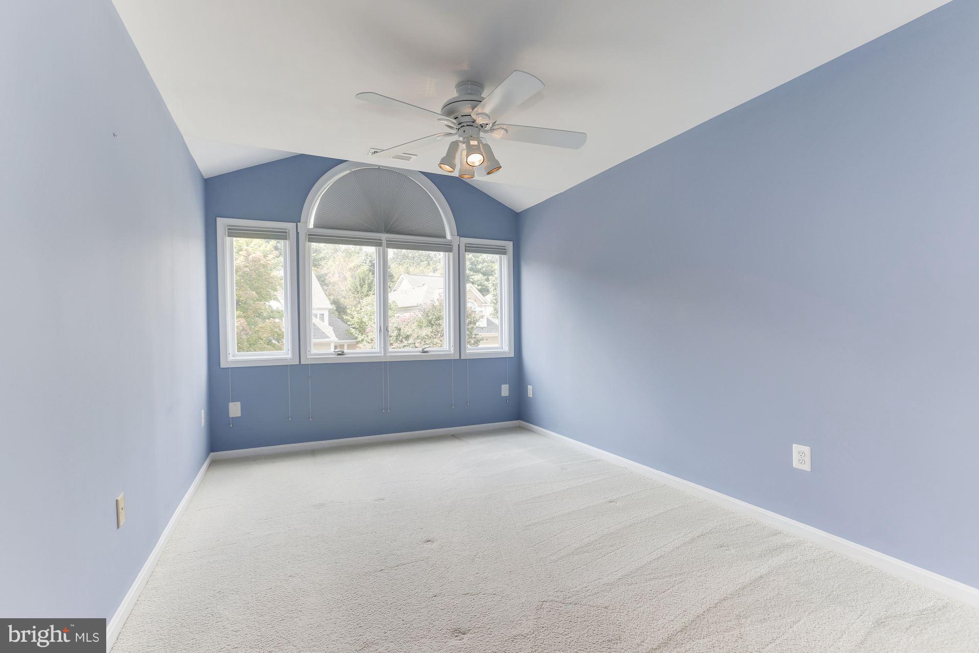 1311 Pavilion Club Way Reston, VA 20194 - Photo 19 of 28 an empty room with a chandelier fan and windows