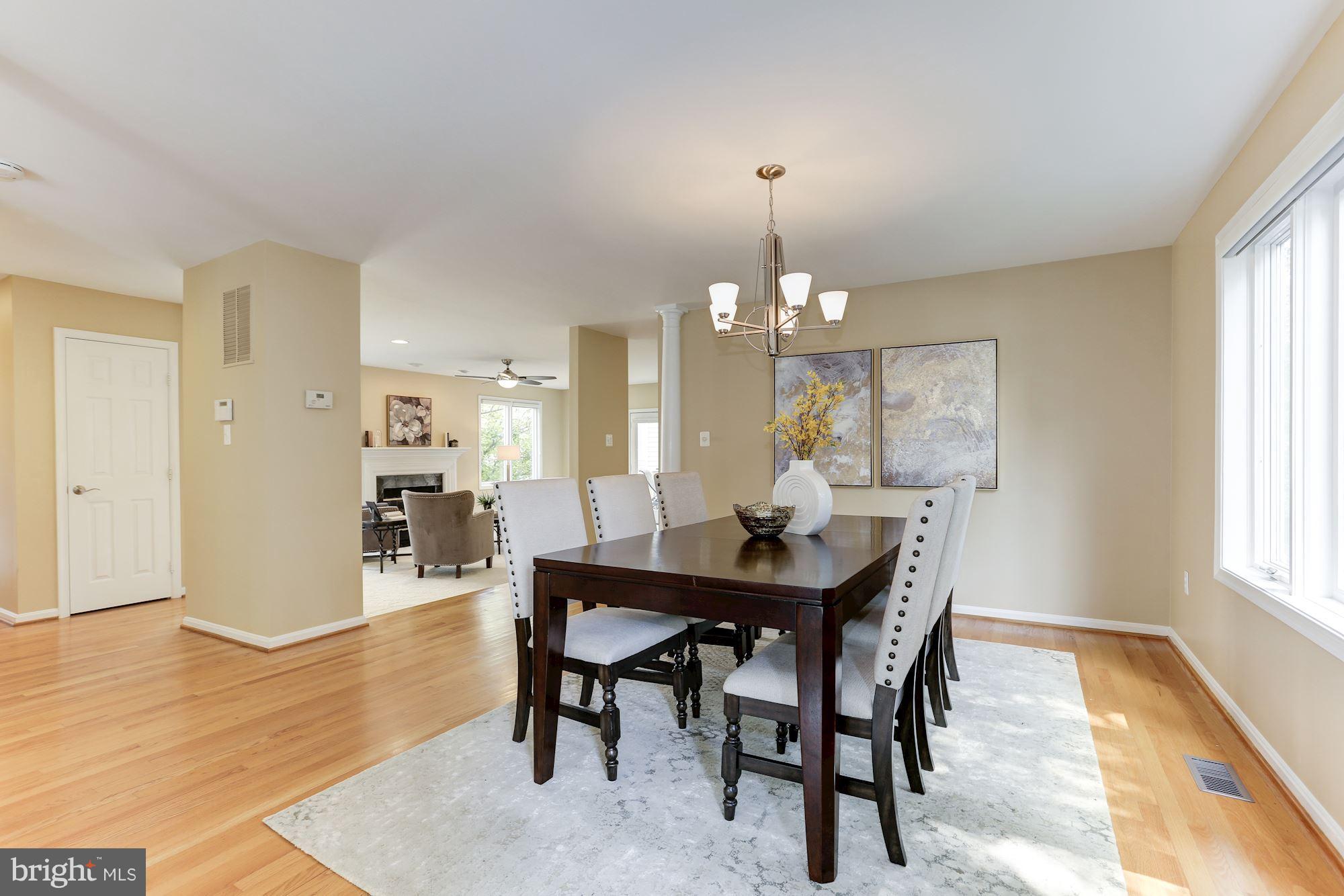 1311 Pavilion Club Way Reston, VA 20194 - Photo 6 of 28 a view of a dining room with furniture and wooden floor