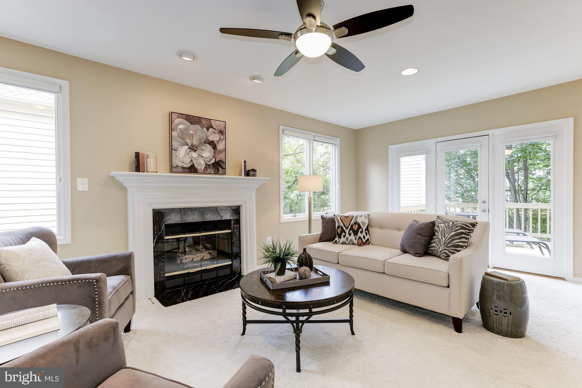 1311 Pavilion Club Way Reston, VA 20194 - Photo 7 of 28 a living room with furniture a fireplace and a large window