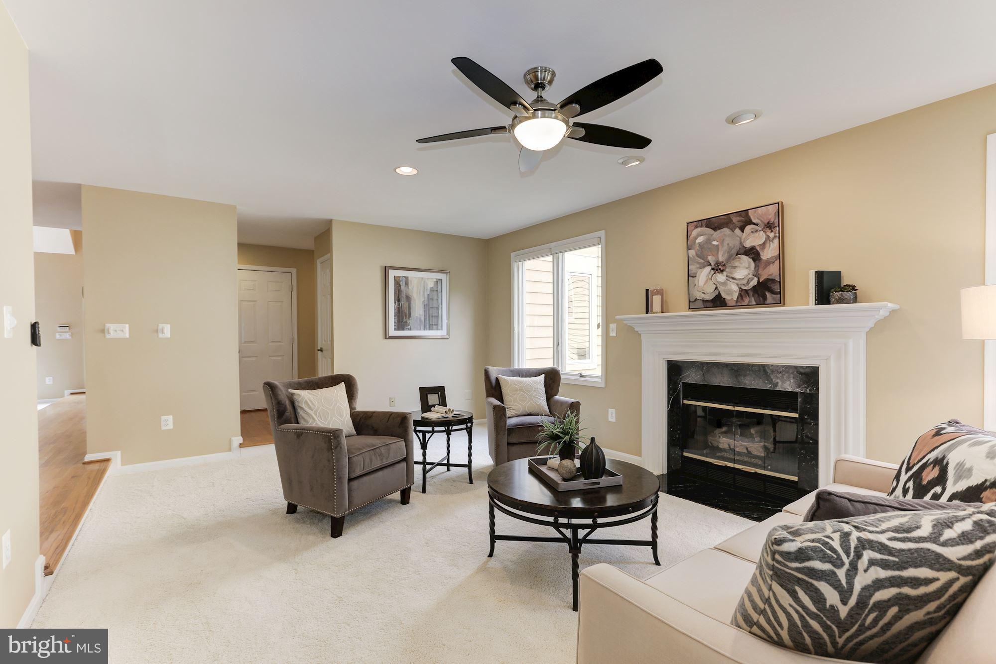 1311 Pavilion Club Way Reston, VA 20194 - Photo 8 of 28 a living room with furniture and a fireplace