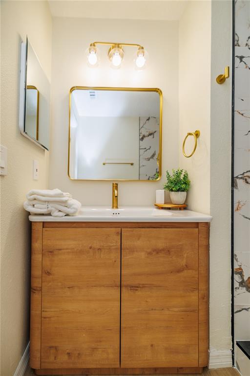 6922 Woodlake Drive, Unit 103 Orlando, FL 32810 - Photo 13 of 16 a bathroom with a sink and a mirror