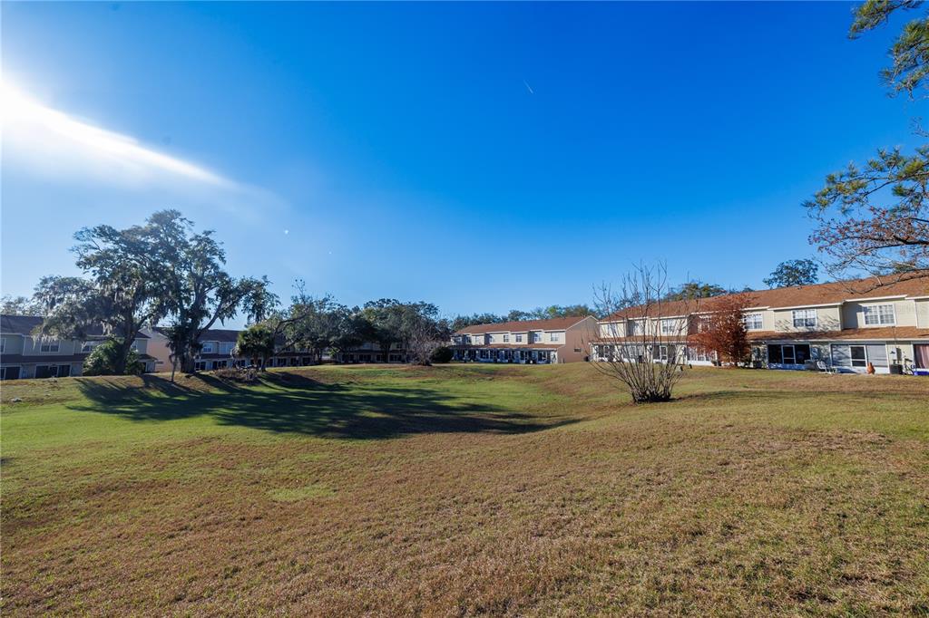 6922 Woodlake Drive, Unit 103 Orlando, FL 32810 - Photo 16 of 16 a view of a big house with a big yard