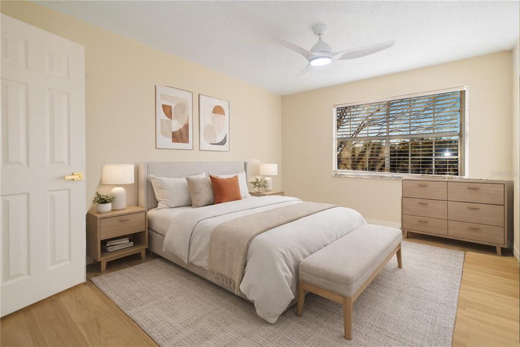6922 Woodlake Drive, Unit 103 Orlando, FL 32810 - Photo 6 of 16 a bedroom with a bed and a dresser