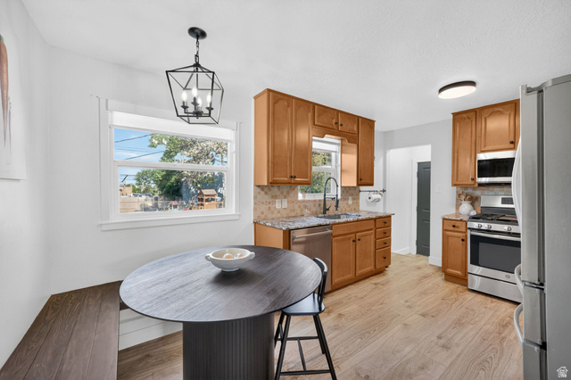 66 South 425 West Bountiful, UT 84010 - Photo 7 of 25 Kitchen featuring wood-finish flooring, light wood cabinetry, stone-finish countertops, and stainless steel appliances