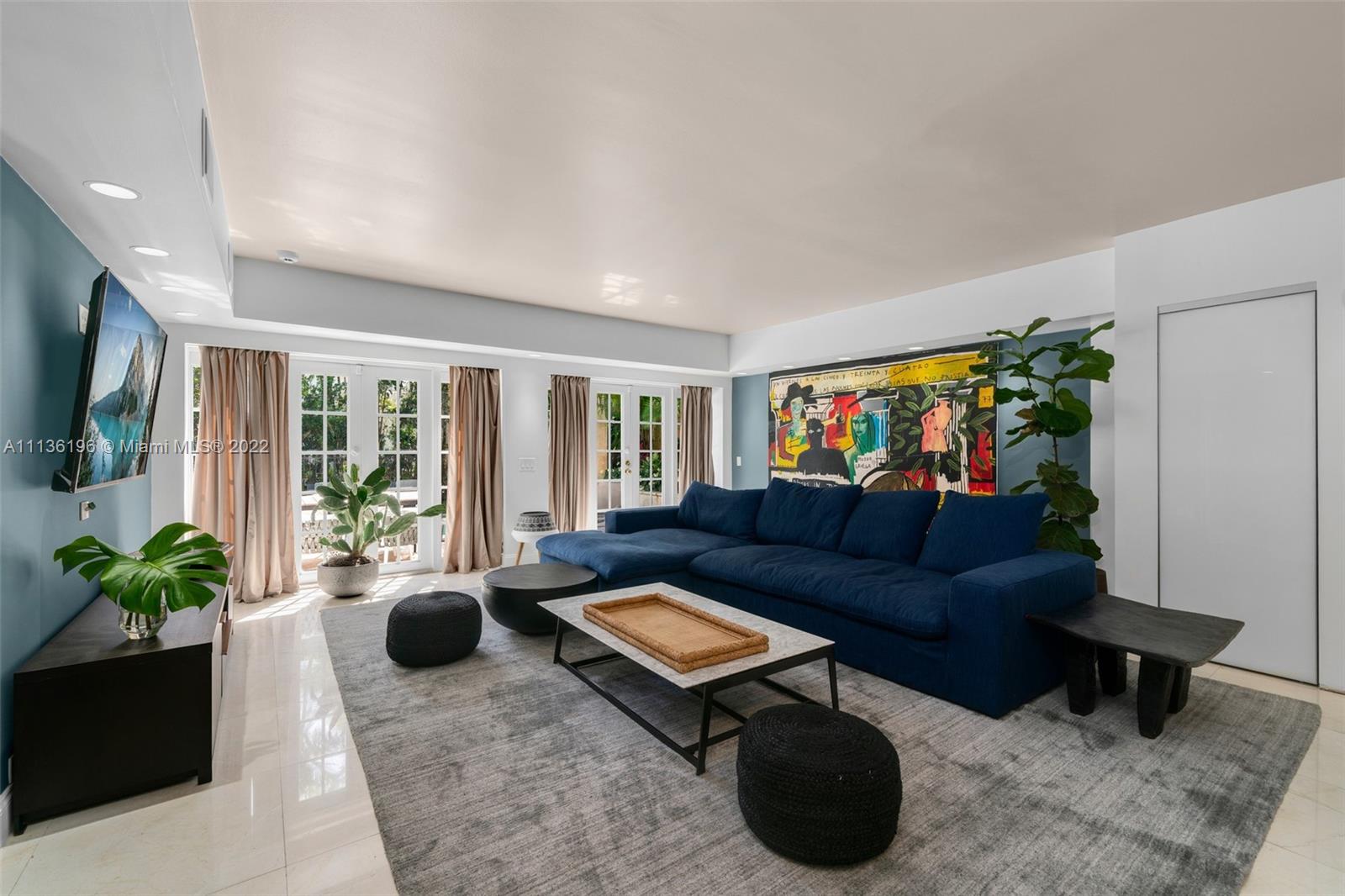 5852 Pine Tree Drive Miami Beach, FL 33140 - Photo 15 of 53 a living room with furniture potted plant and a window