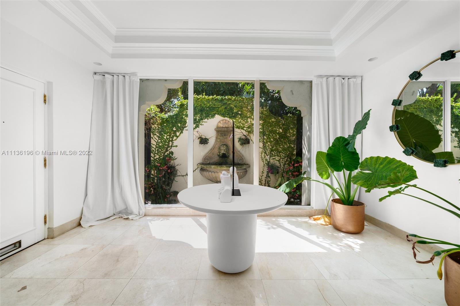 5852 Pine Tree Drive Miami Beach, FL 33140 - Photo 2 of 53 a dining room with furniture and garden view