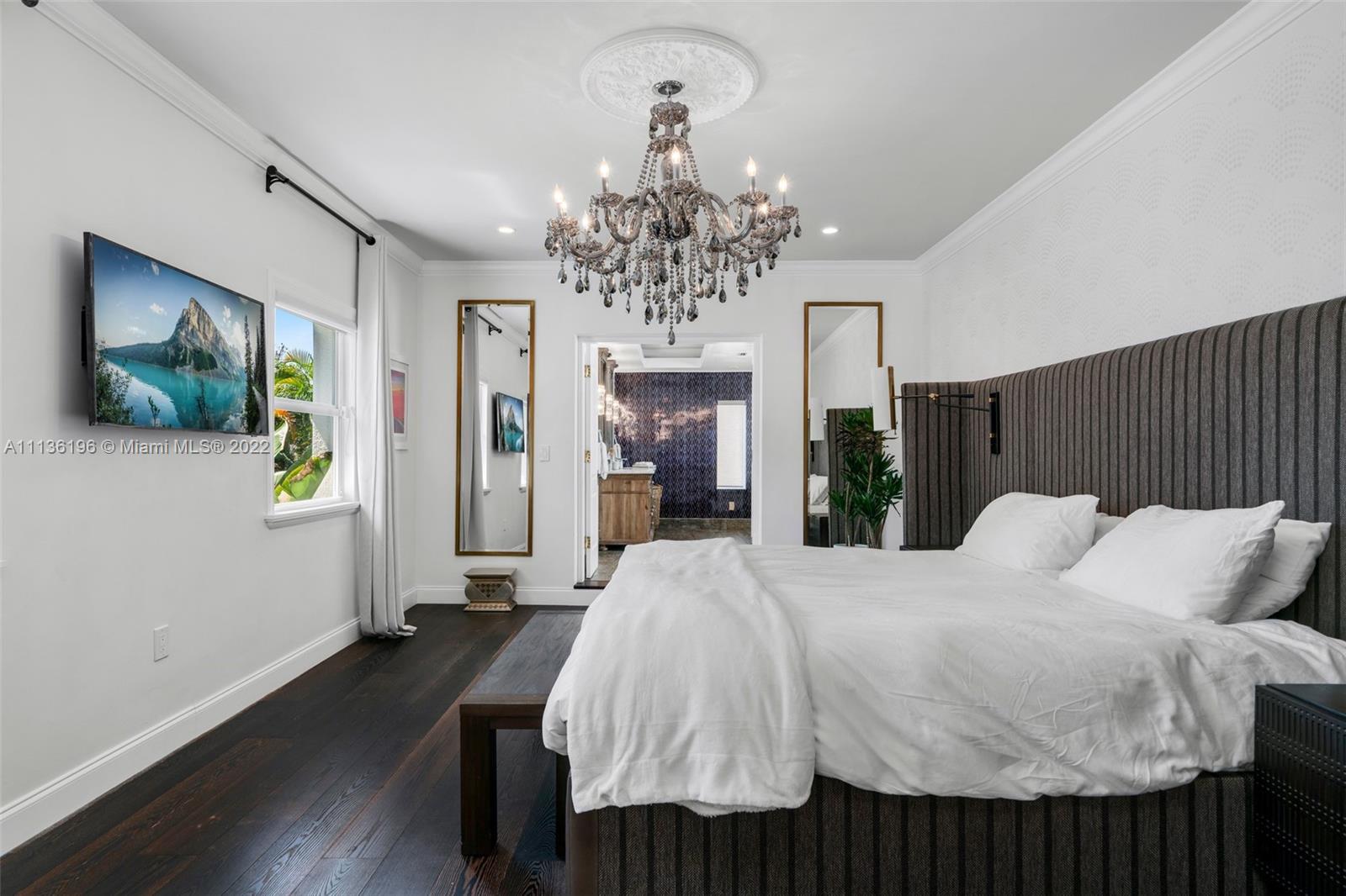 5852 Pine Tree Drive Miami Beach, FL 33140 - Photo 22 of 53 a bed room with a bed mirror and a window