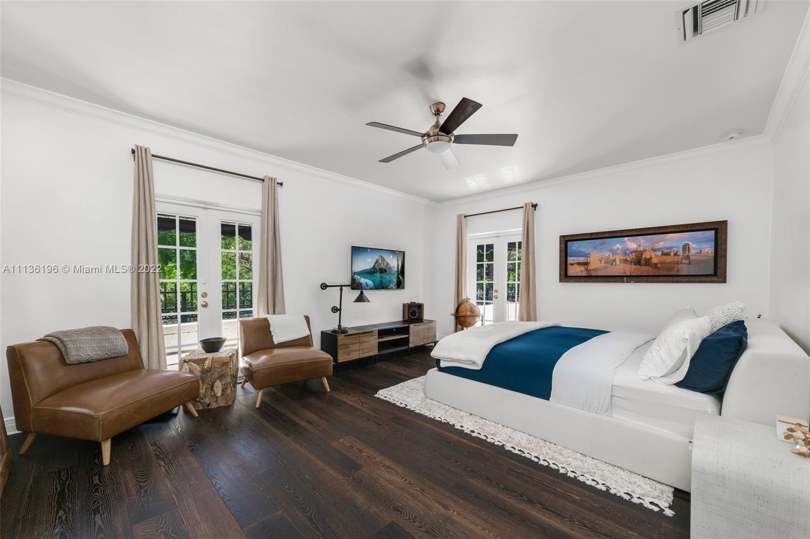 5852 Pine Tree Drive Miami Beach, FL 33140 - Photo 26 of 53 a living room with furniture large window and a wooden floor