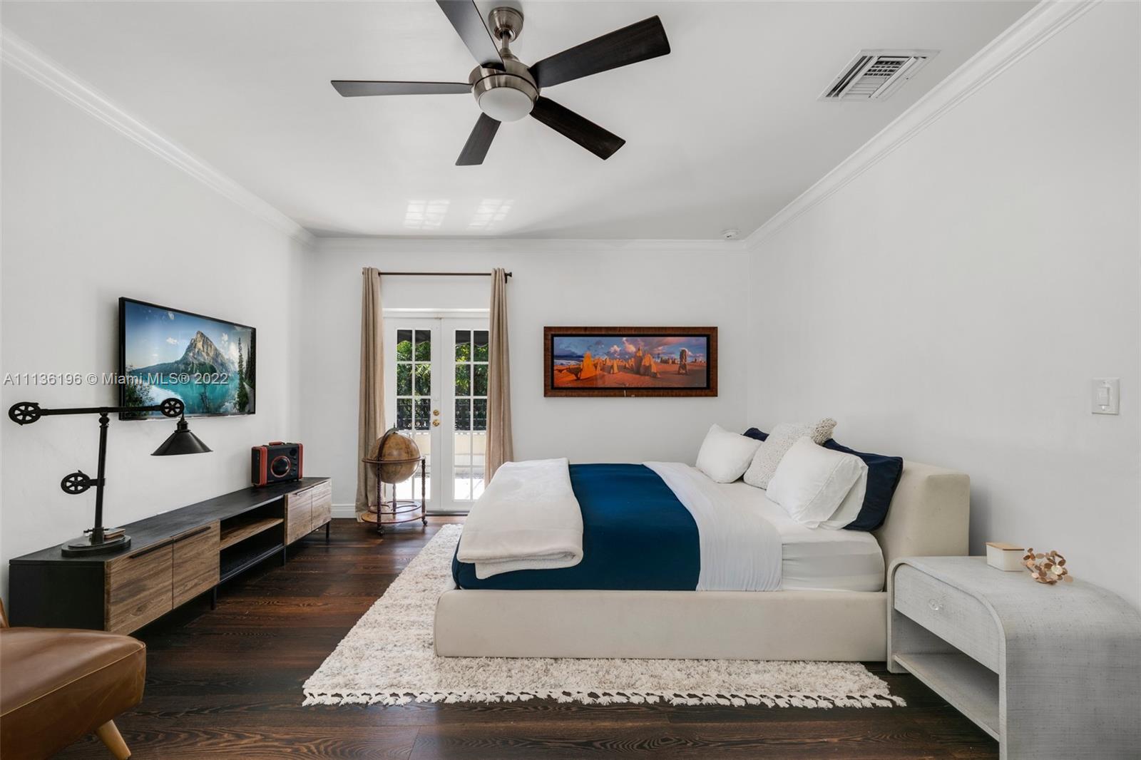 5852 Pine Tree Drive Miami Beach, FL 33140 - Photo 27 of 53 a living room with furniture and a flat screen tv