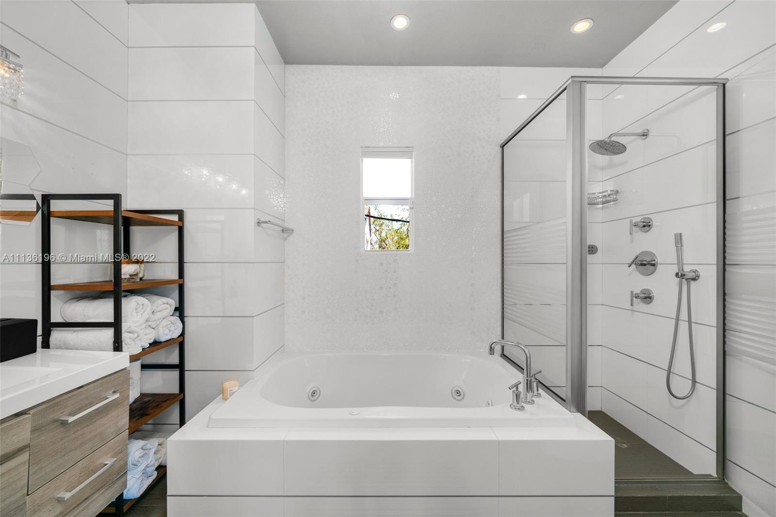 5852 Pine Tree Drive Miami Beach, FL 33140 - Photo 28 of 53 a bathroom with a tub and shower