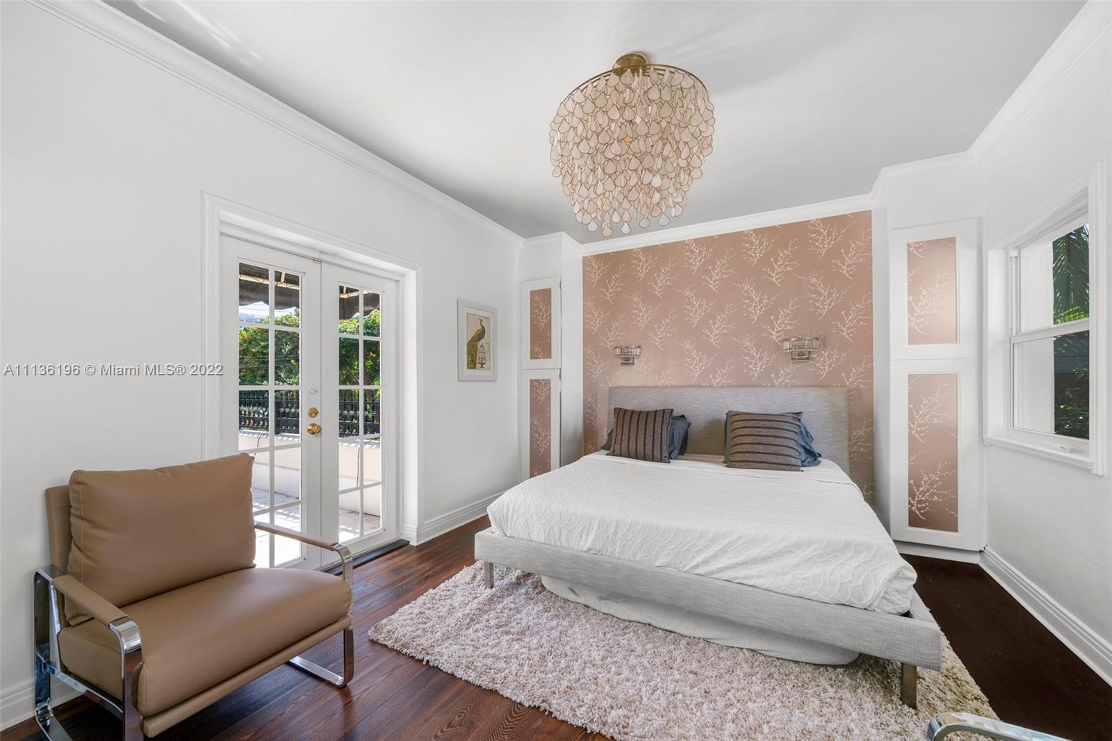 5852 Pine Tree Drive Miami Beach, FL 33140 - Photo 30 of 53 a bedroom with a large bed and a couch