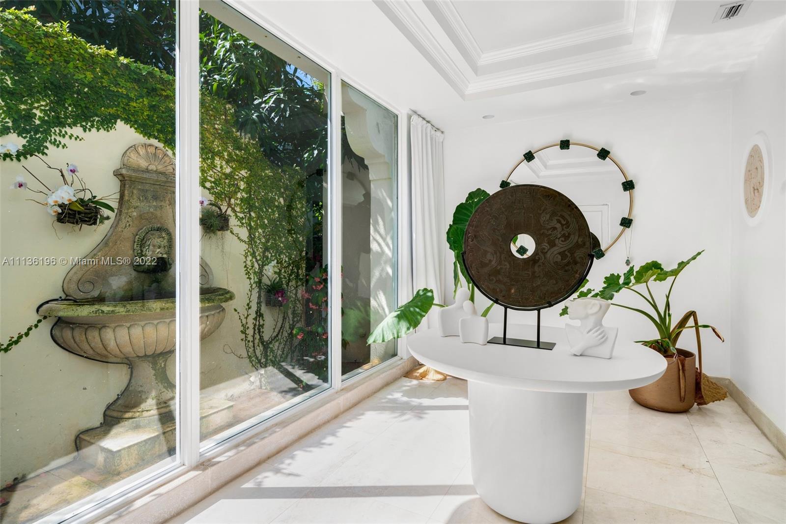 5852 Pine Tree Drive Miami Beach, FL 33140 - Photo 3 of 53 a vase of flowers sitting on a table with garden view