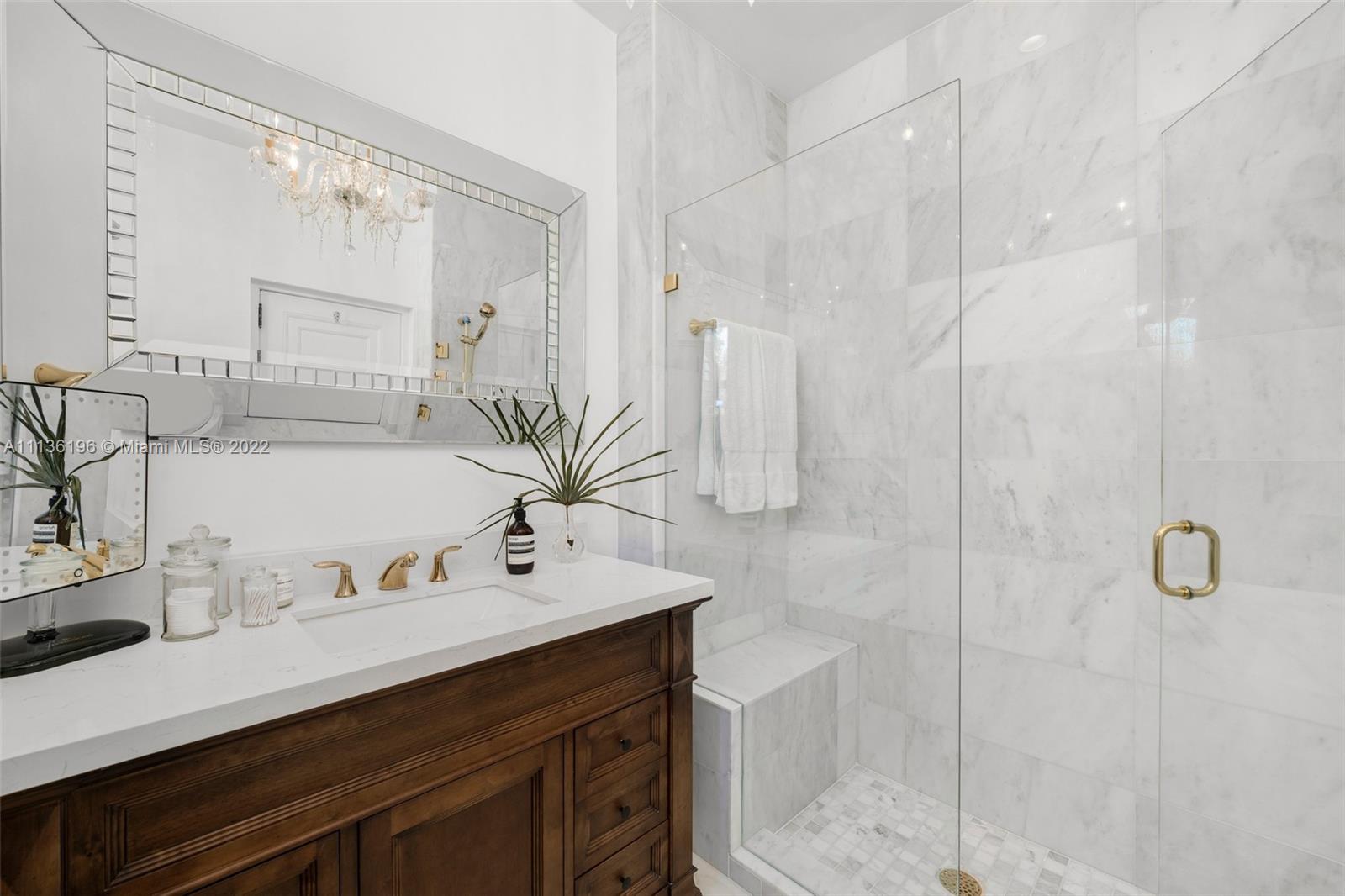 5852 Pine Tree Drive Miami Beach, FL 33140 - Photo 32 of 53 a bathroom with a double vanity sink mirror and shower