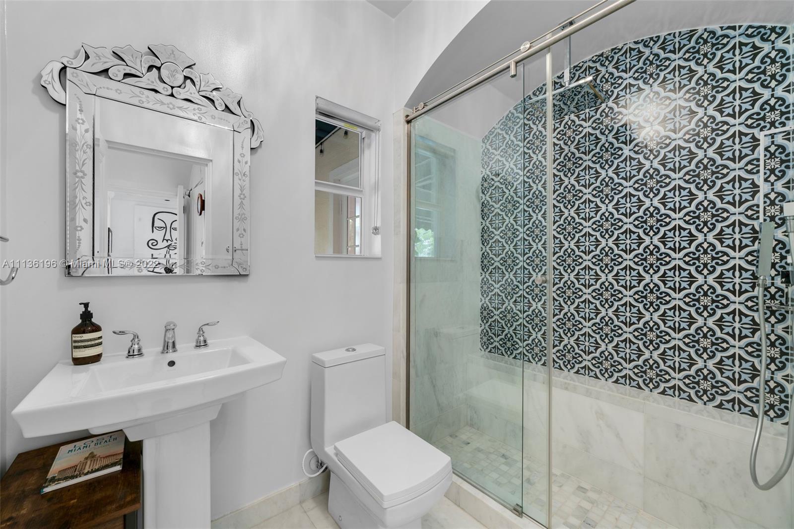 5852 Pine Tree Drive Miami Beach, FL 33140 - Photo 35 of 53 a bathroom with a sink toilet and vanity