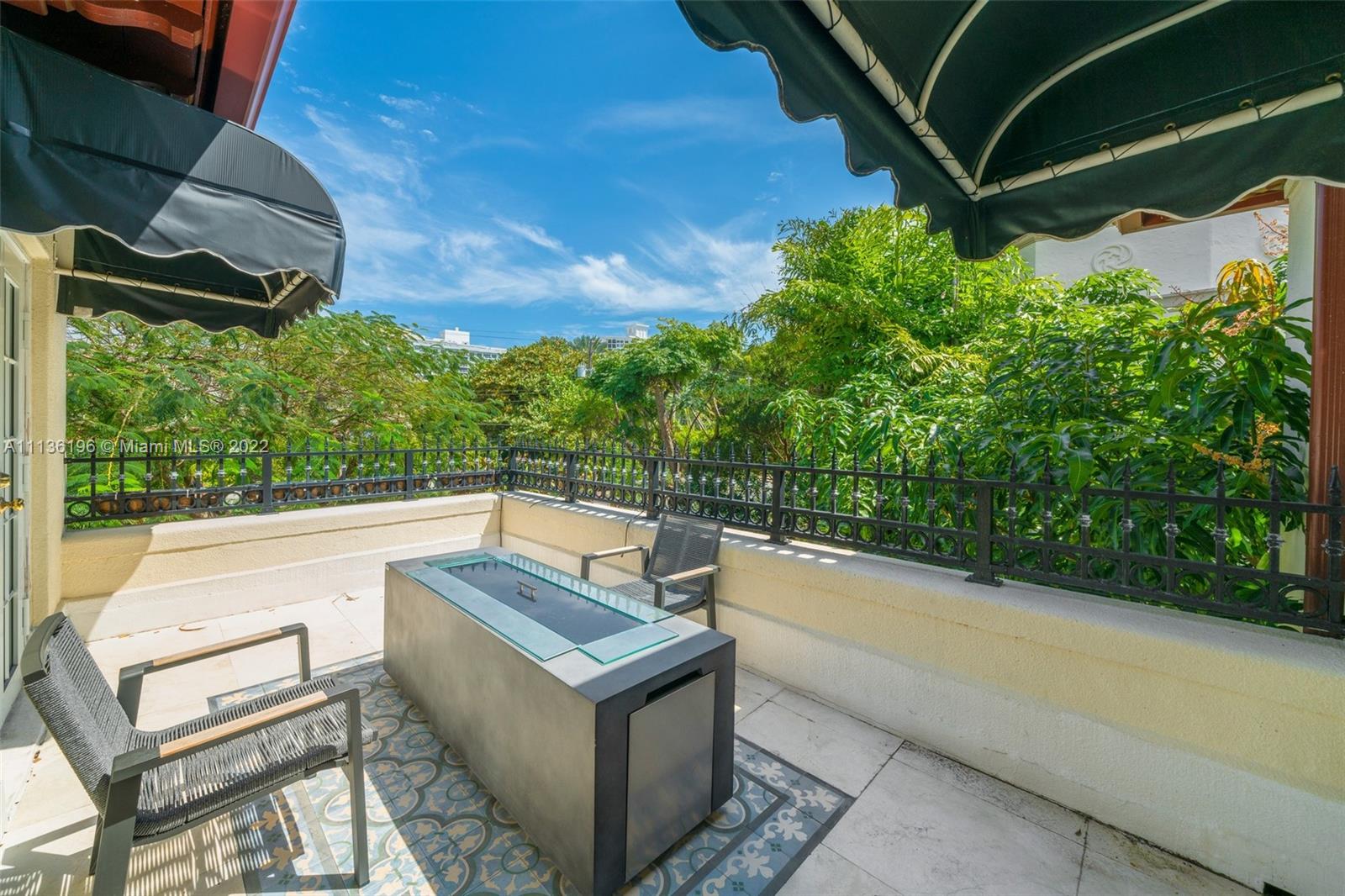 5852 Pine Tree Drive Miami Beach, FL 33140 - Photo 37 of 53 a view of a chairs and table in a patio
