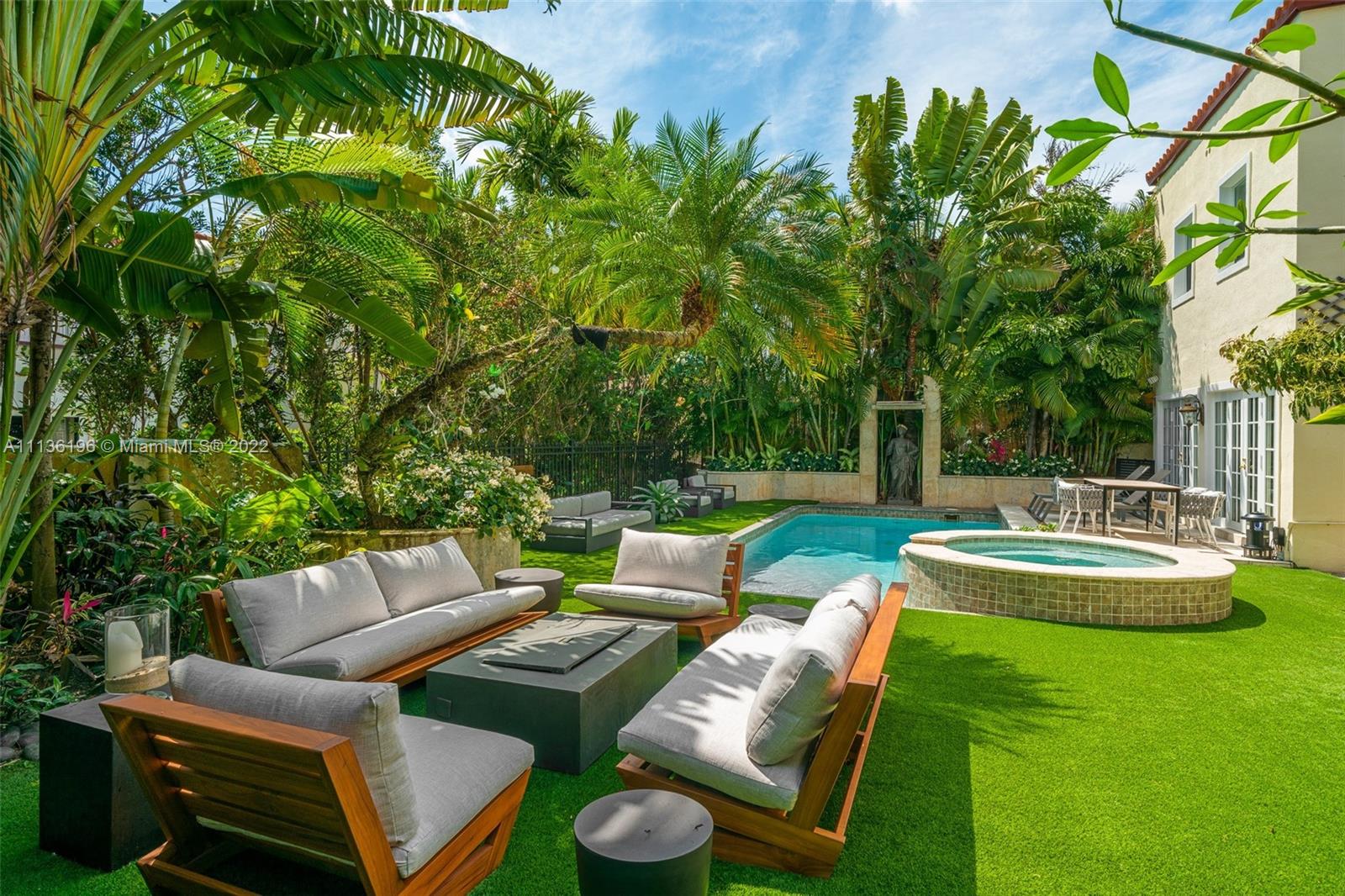 5852 Pine Tree Drive Miami Beach, FL 33140 - Photo 39 of 53 a view of a backyard with swimming pool and chairs