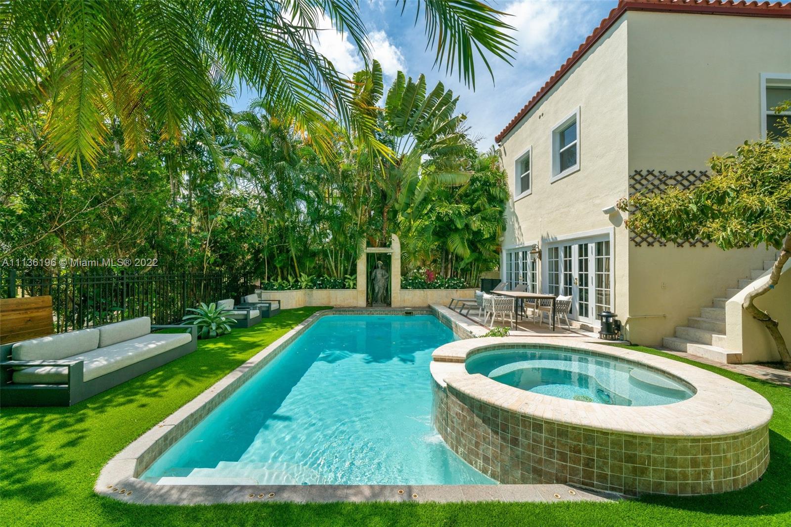 5852 Pine Tree Drive Miami Beach, FL 33140 - Photo 42 of 53 a view of a house with swimming pool and sitting area