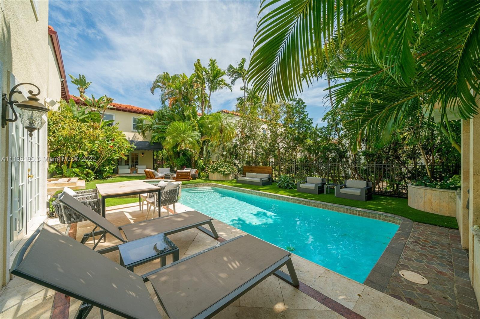 5852 Pine Tree Drive Miami Beach, FL 33140 - Photo 44 of 53 a view of a yard with furniture