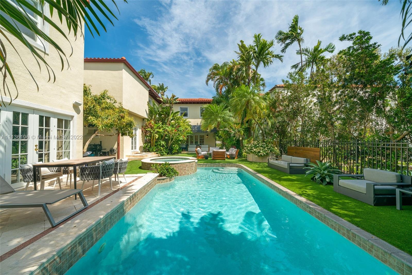 5852 Pine Tree Drive Miami Beach, FL 33140 - Photo 45 of 53 a view of a house with swimming pool and sitting area