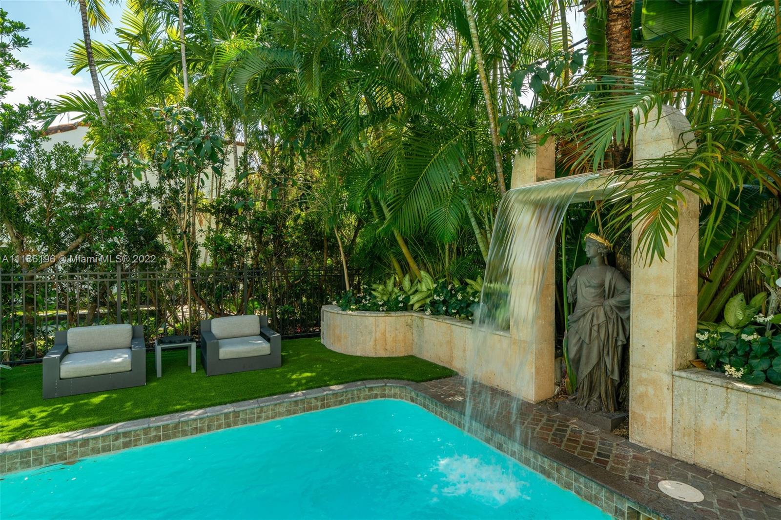 5852 Pine Tree Drive Miami Beach, FL 33140 - Photo 46 of 53 a view of a garden with a bench