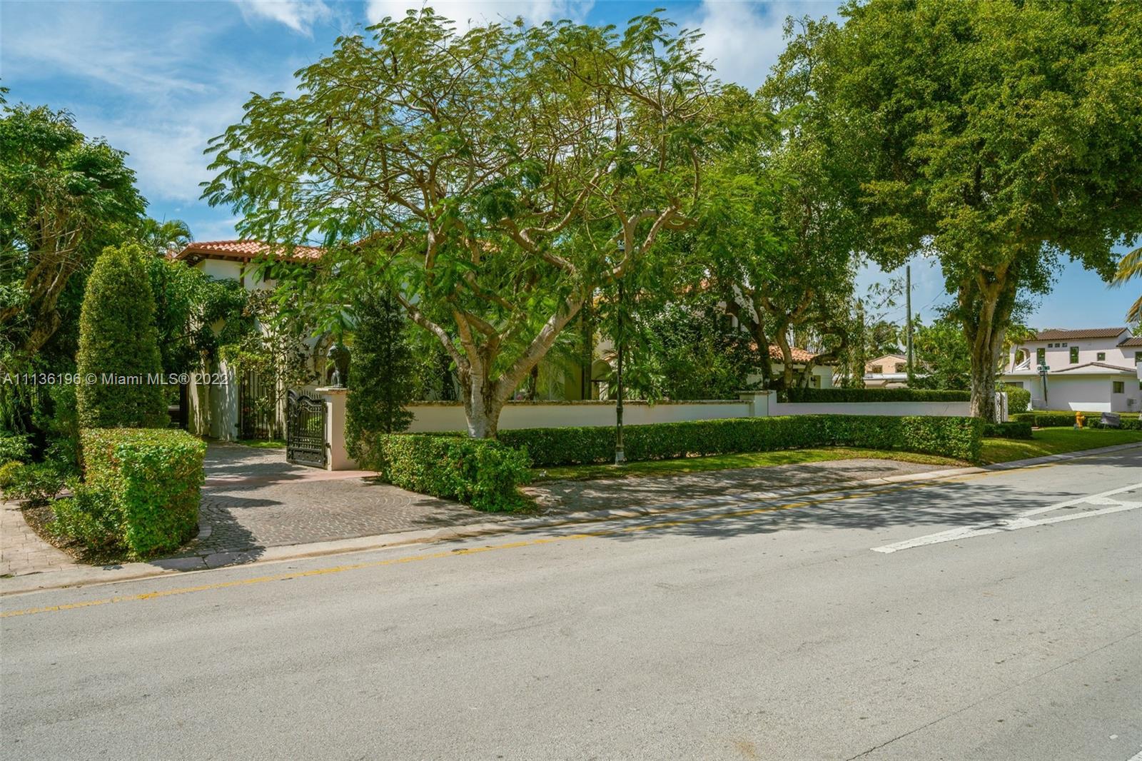 5852 Pine Tree Drive Miami Beach, FL 33140 - Photo 50 of 53 a backyard of a house with lots of green space