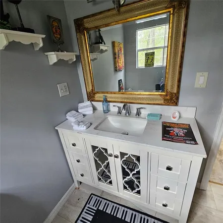 a bathroom with a sink and a mirror