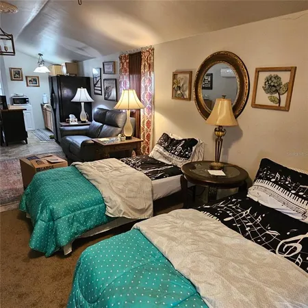 a bedroom with two beds and a mirror