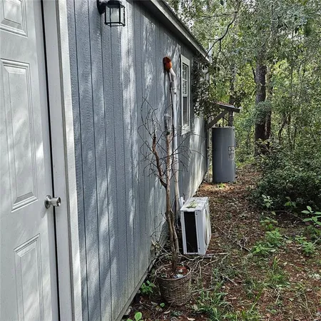 a view of a house with backyard and trees