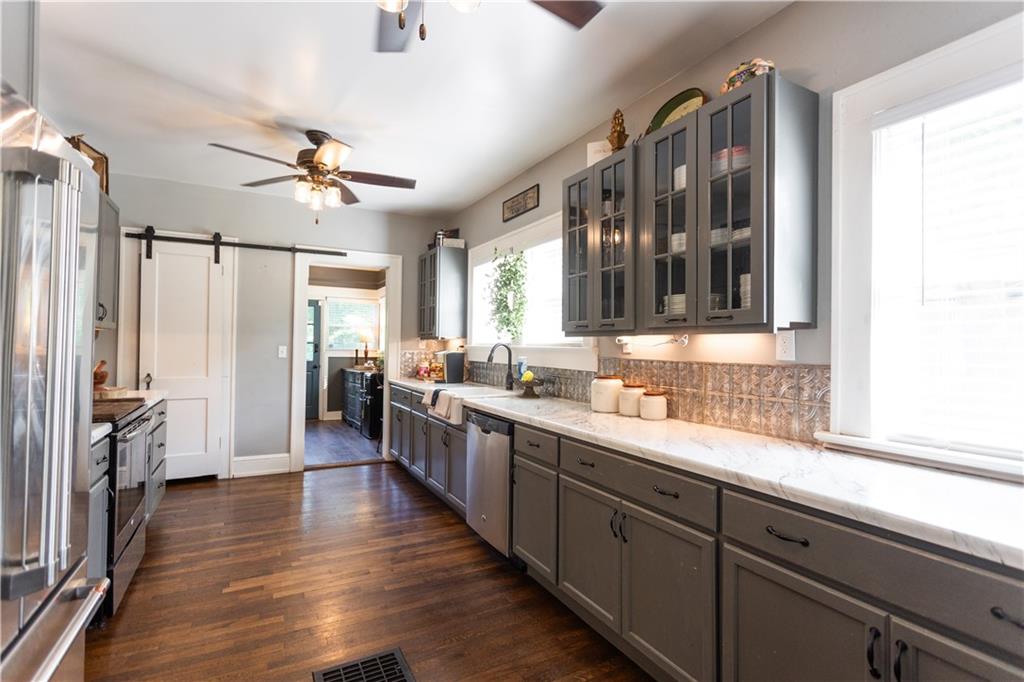 346 North Cherokee Road Social Circle, GA 30025 - Photo 20 of 71 a large kitchen with stainless steel appliances a lot of counter space and a window