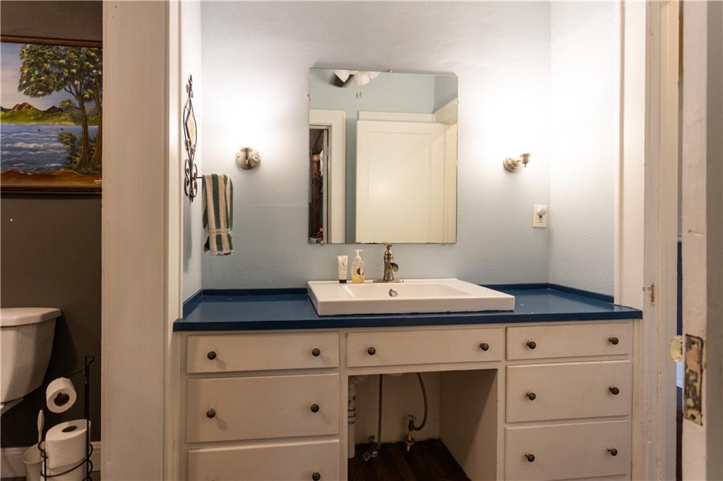 346 North Cherokee Road Social Circle, GA 30025 - Photo 27 of 71 a bathroom with a sink and a mirror