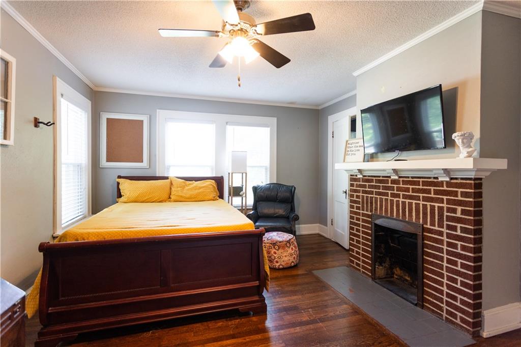 346 North Cherokee Road Social Circle, GA 30025 - Photo 36 of 71 a bedroom with a bed a flat screen tv and a chandelier