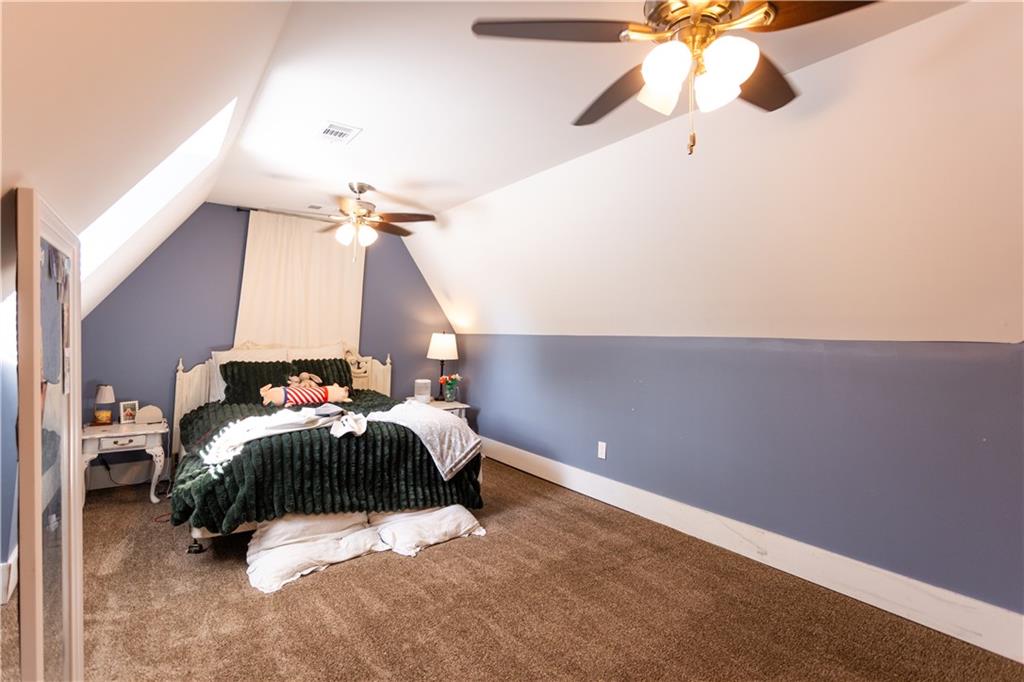 346 North Cherokee Road Social Circle, GA 30025 - Photo 48 of 71 a bedroom with a bed and a chandelier fan