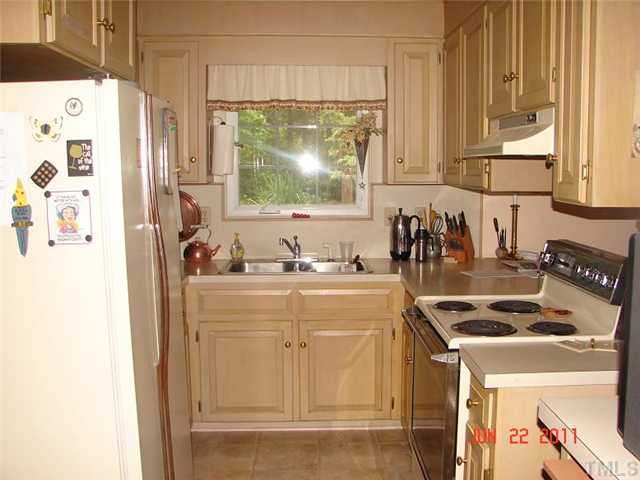 2113 Jordan Cabin Road Wendell, NC 27591 - Photo 10 of 20 Kitchen with side by side refrig, stove & dishwasher