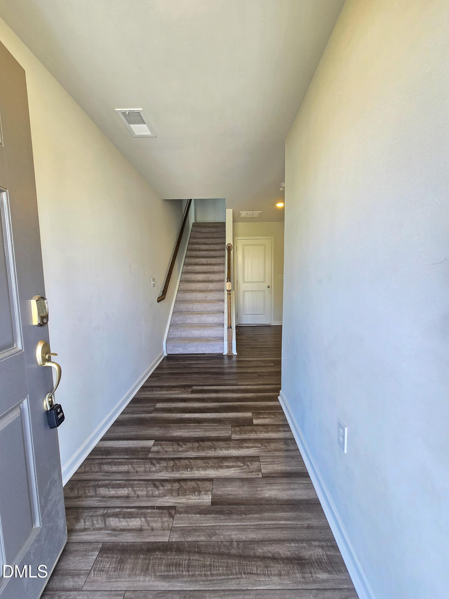 2431 Kasota Lane Raleigh, NC 27610 - Photo 3 of 46 a view of a hallway with wooden floor and stairs