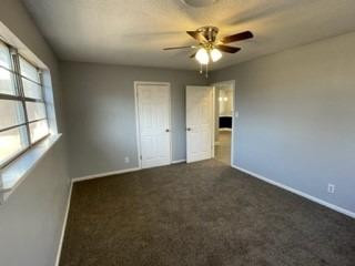 5435 42nd Street Lubbock, TX 79414 - Photo 8 of 12 an empty room with chandelier fan and windows