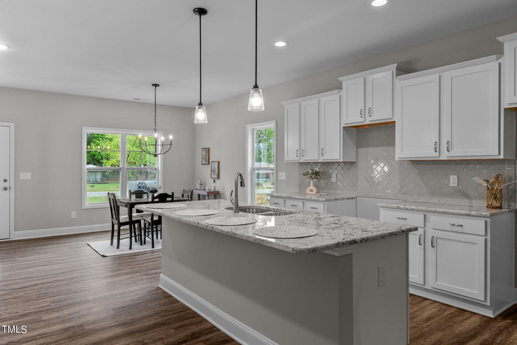 57 Regis Lane Coats, NC 27521 - Photo 13 of 39 a kitchen with appliances cabinets and wooden floor