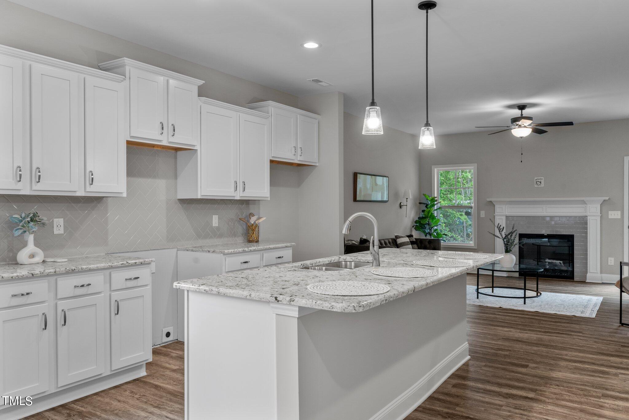 57 Regis Lane Coats, NC 27521 - Photo 14 of 39 a kitchen with kitchen island a sink stainless steel appliances and cabinets