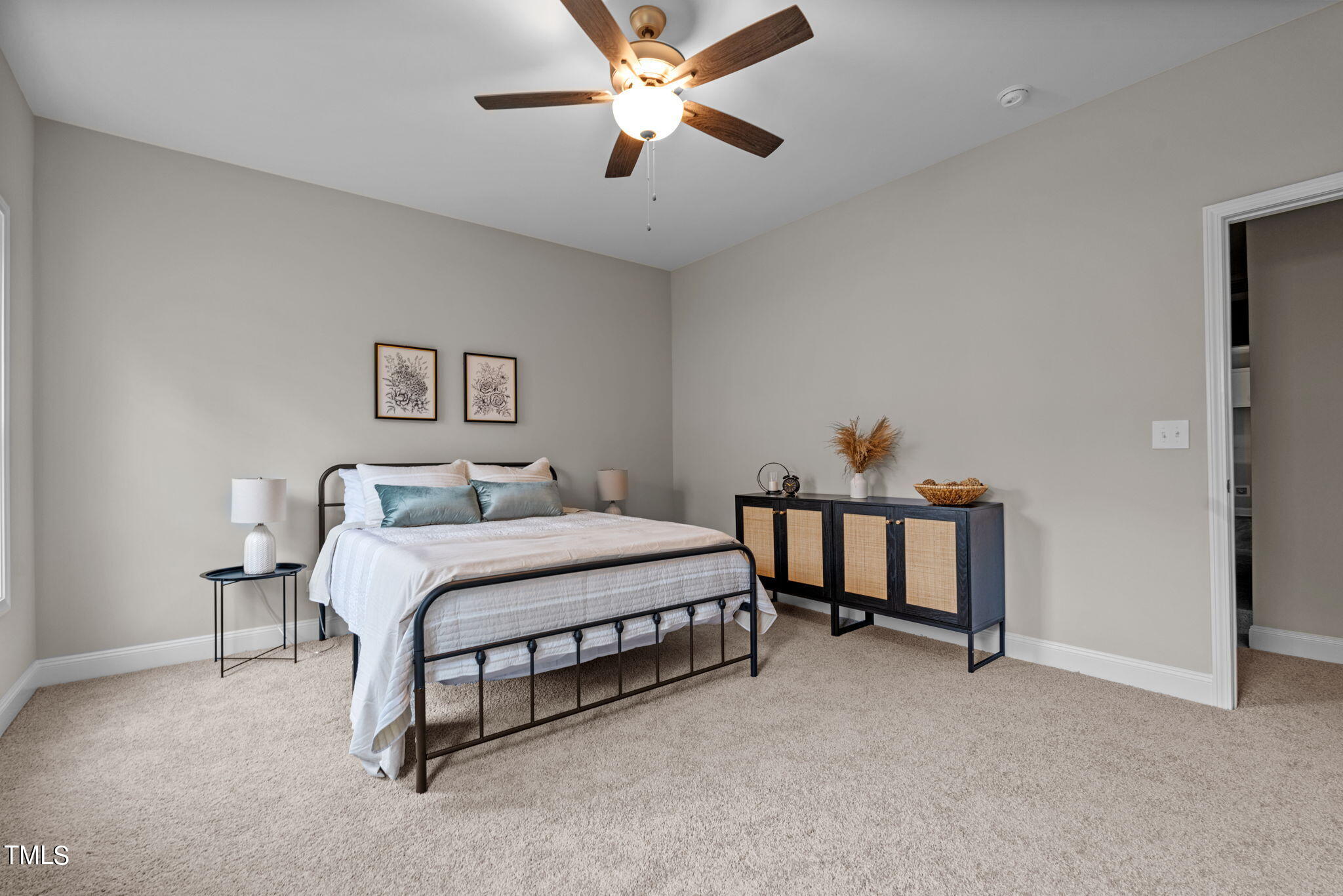 57 Regis Lane Coats, NC 27521 - Photo 23 of 39 a bedroom with a bed and a chandelier