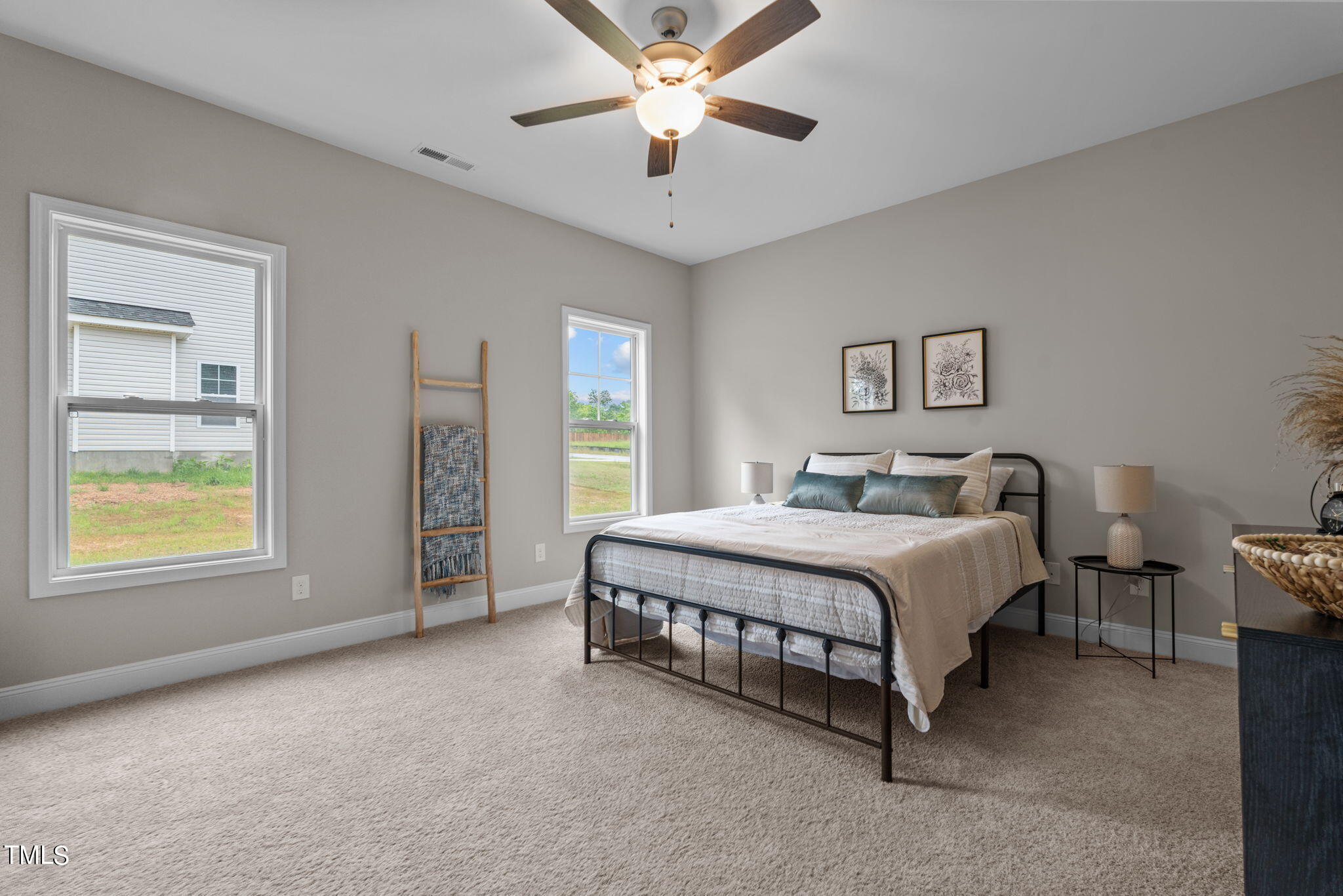 57 Regis Lane Coats, NC 27521 - Photo 24 of 39 a spacious bedroom with a bed and a chandelier