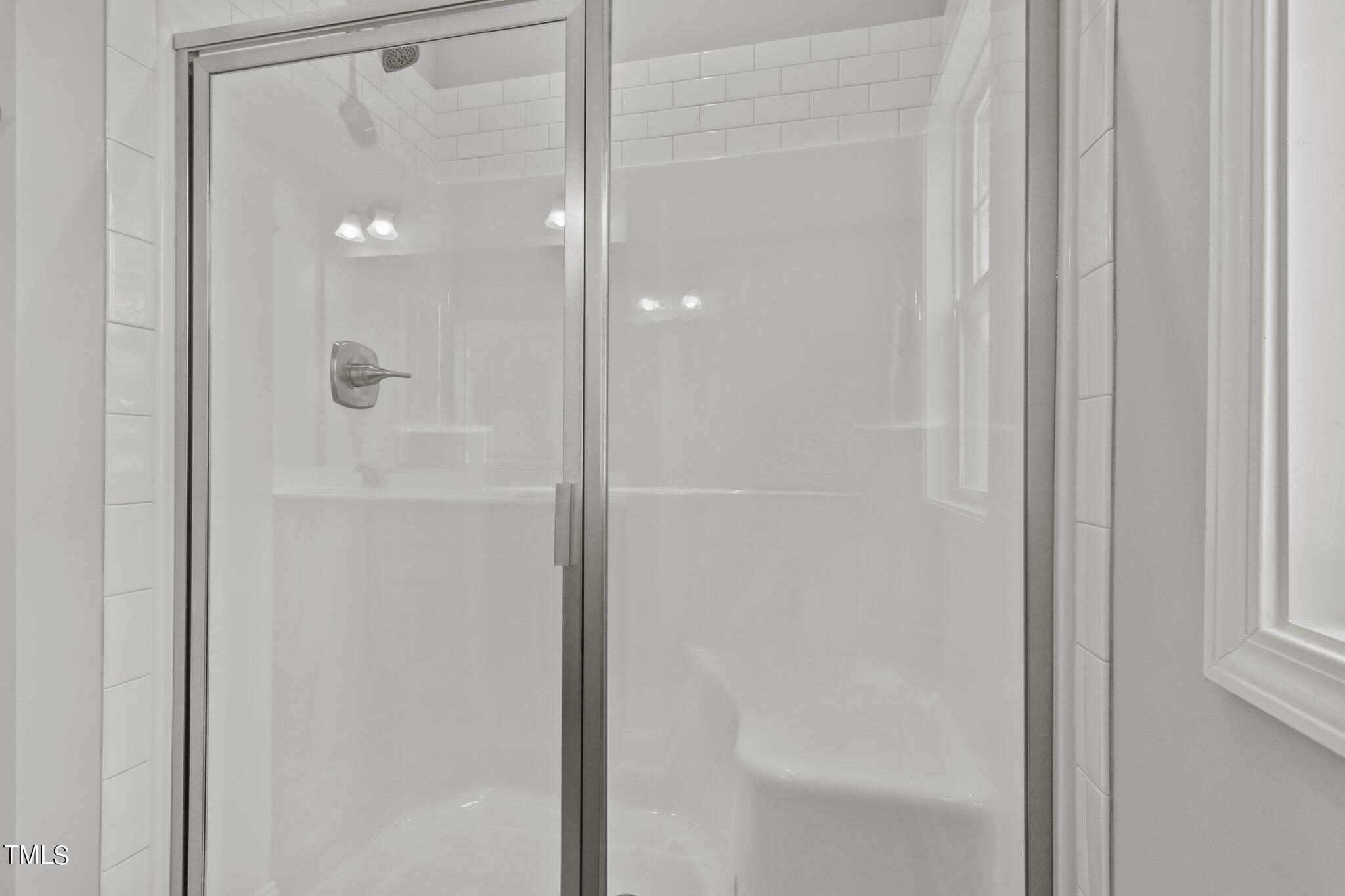 57 Regis Lane Coats, NC 27521 - Photo 27 of 39 a bathroom with a glass shower door