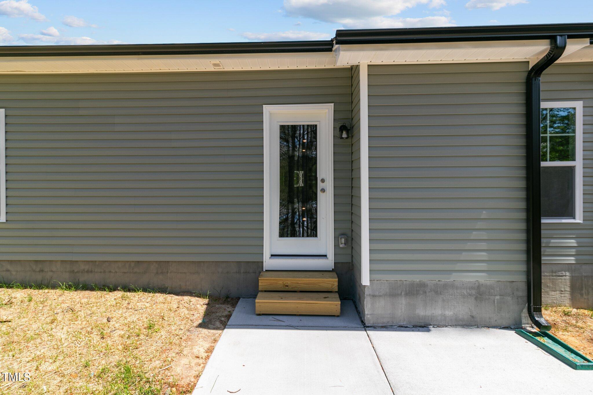 57 Regis Lane Coats, NC 27521 - Photo 30 of 39 a view of a entryway door front of house