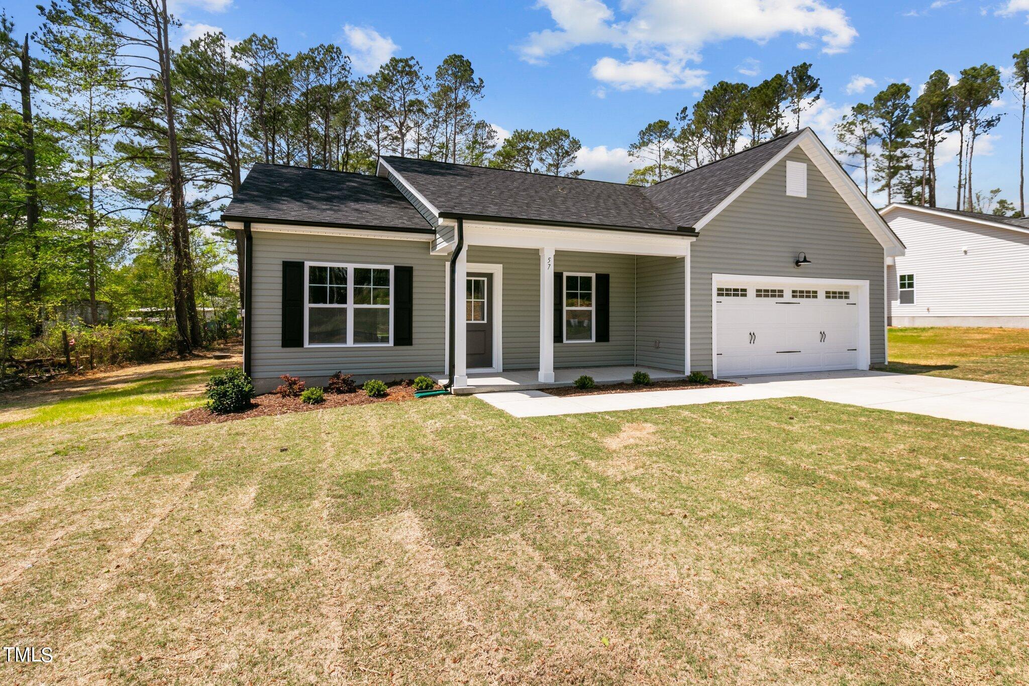 57 Regis Lane Coats, NC 27521 - Photo 3 of 39 a view of a house with a backyard
