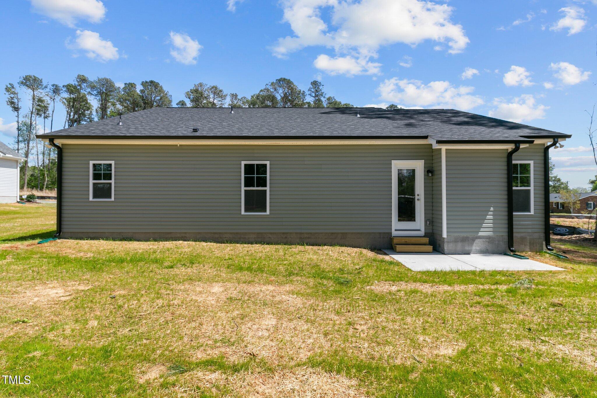 57 Regis Lane Coats, NC 27521 - Photo 32 of 39 a view of a house with a yard