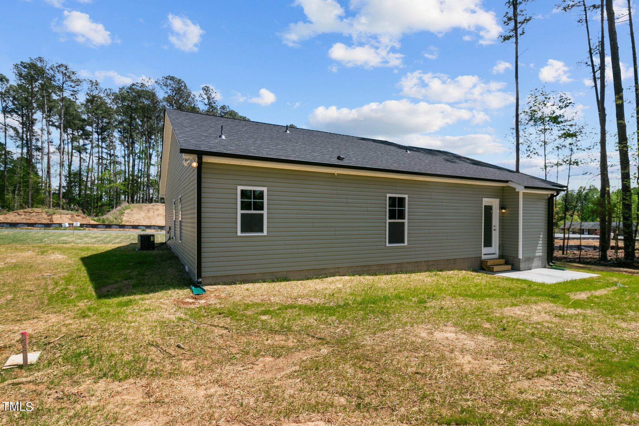 57 Regis Lane Coats, NC 27521 - Photo 36 of 39 a backyard of a house with table and chairs