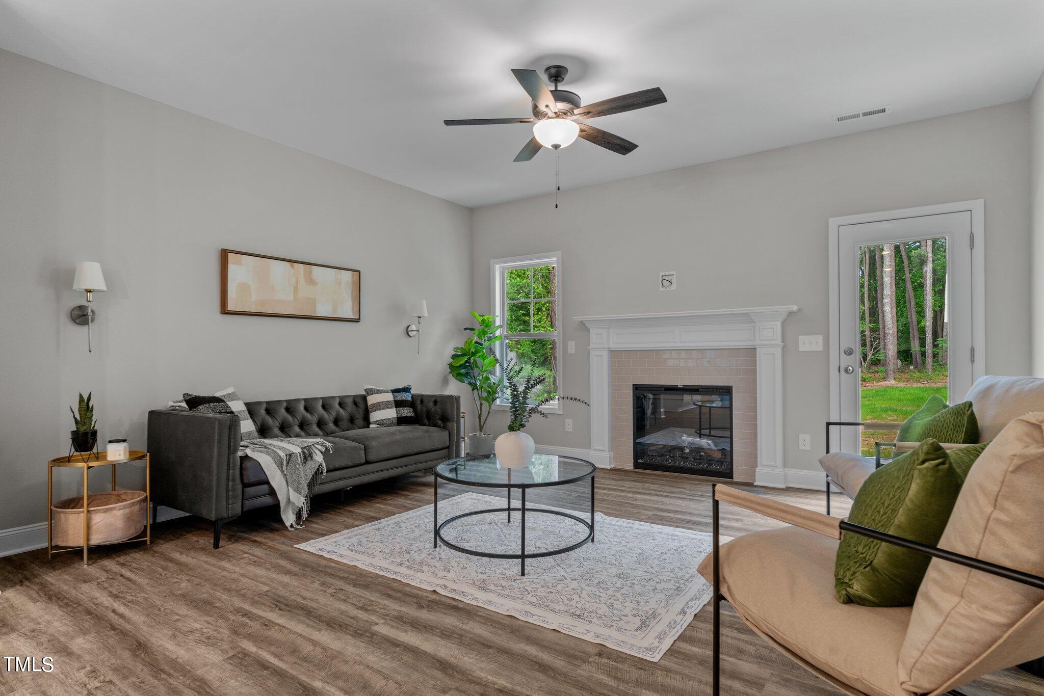 57 Regis Lane Coats, NC 27521 - Photo 5 of 39 a living room with furniture a fireplace and a large mirror