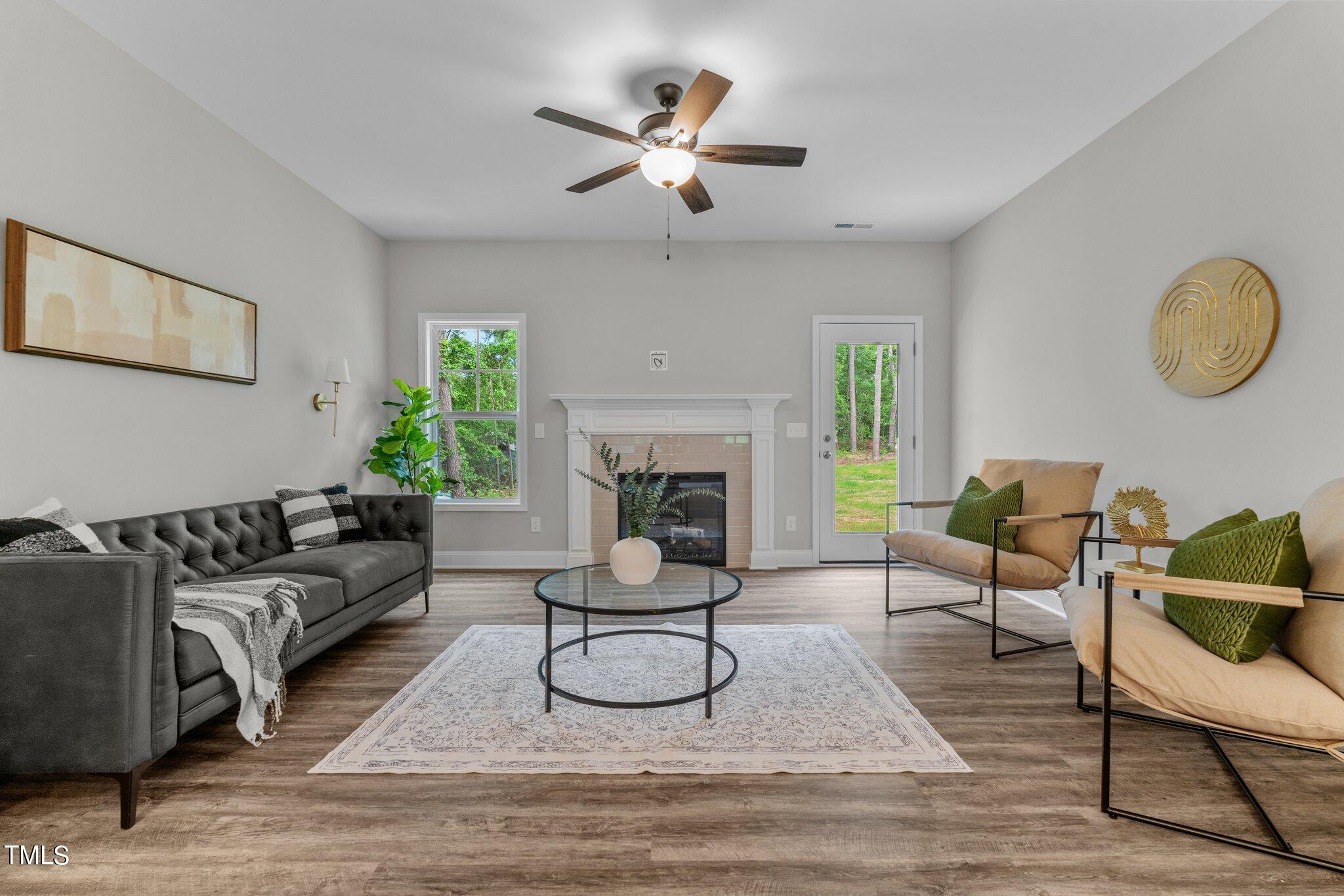 57 Regis Lane Coats, NC 27521 - Photo 6 of 39 a living room with furniture a fireplace and a table