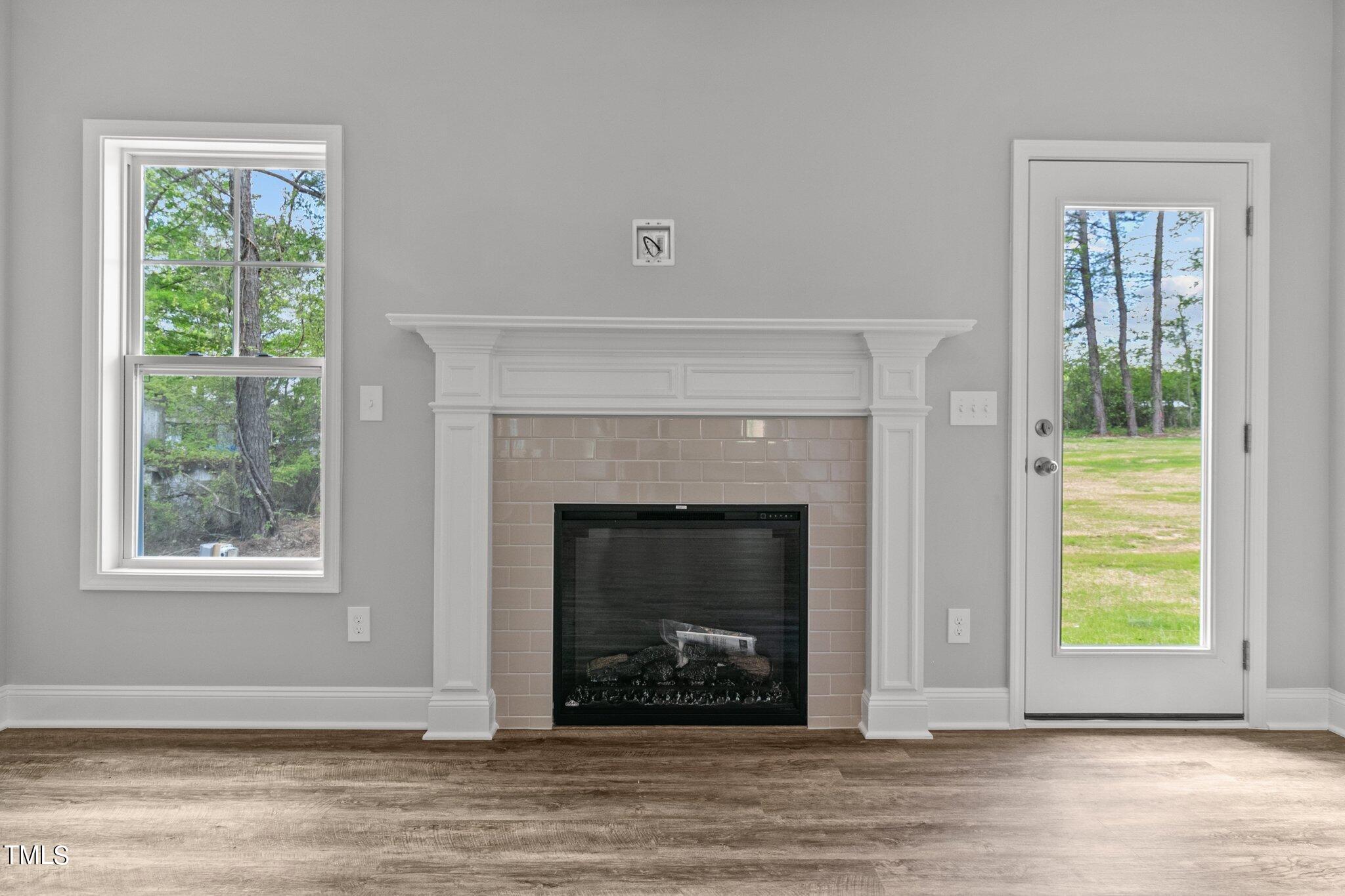 57 Regis Lane Coats, NC 27521 - Photo 9 of 39 a living room with a fireplace and windows