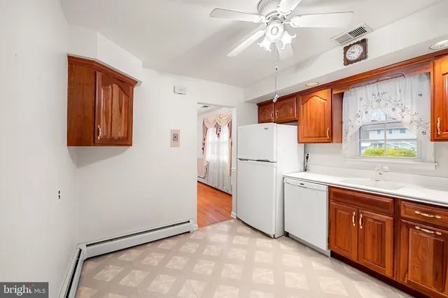 a kitchen with cabinets a island and appliances