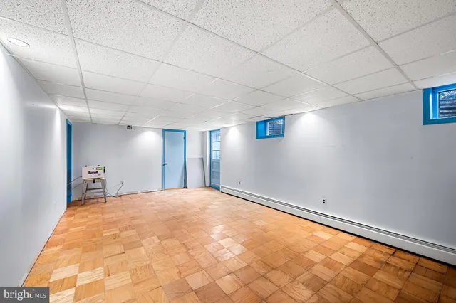 a view of empty room with window and wooden floor